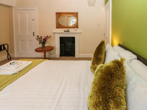 a large white bed with furry pillows in a bedroom at The Old Assembly Rooms in Bishop Auckland