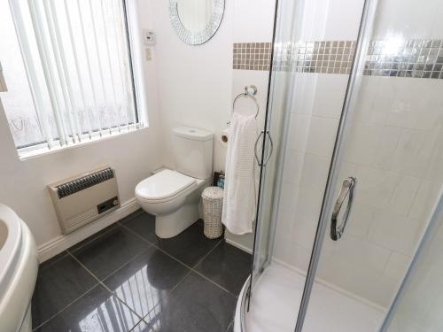 a bathroom with a toilet and a glass shower at The Old Assembly Rooms in Bishop Auckland