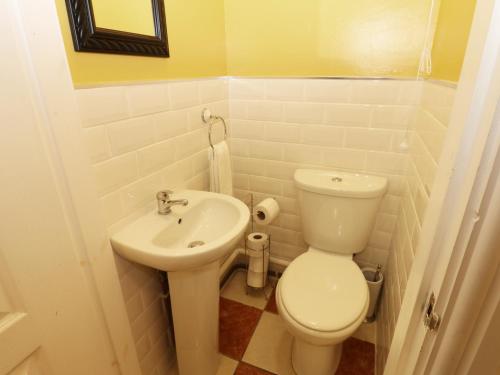a small bathroom with a toilet and a sink at The Old Assembly Rooms in Bishop Auckland