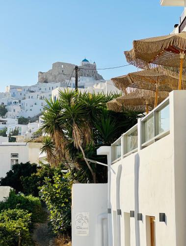 a view of the acropolis from behind a white building at Gerani Deluxe Houses in Astypalaia Town