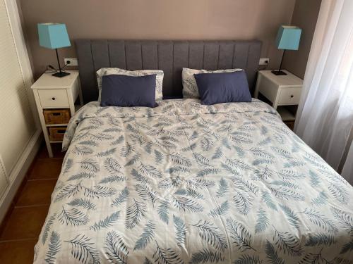 a bedroom with a bed with blue pillows at Apartementos Almerimar Golf in Almerimar