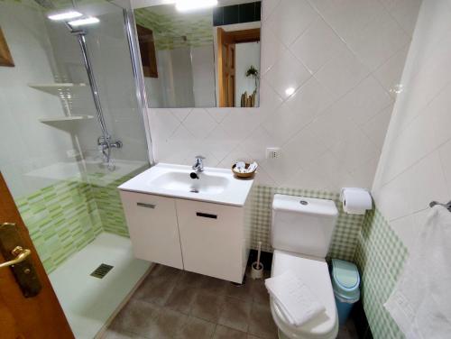 a bathroom with a toilet and a sink and a shower at Villas Rodríguez in Playa Blanca