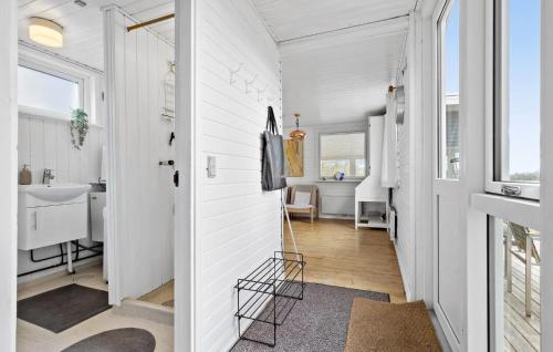 uma casa de banho com paredes brancas e um corredor com um lavatório. em Cozy Home In Ebeltoft With Kitchen em Ebeltoft