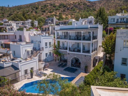 an aerial view of a villa with a swimming pool at Noa Suite Hotel Only Adult in Bodrum City