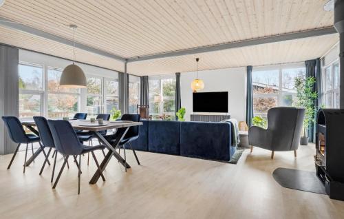 a dining room and living room with a table and chairs at 3 Bedroom Stunning Home In Fårvang in Fårvang