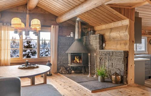 a living room with a fireplace in a cabin at 3 Bedroom Amazing Home In Gol in Gol