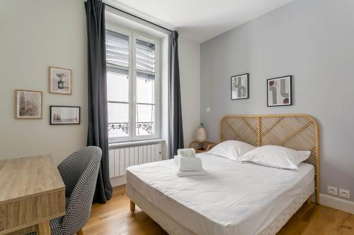 a bedroom with a bed and a table and a window at Hamac Suites - Le Bayard - 2 Bedrooms - Lyon 2 in Lyon