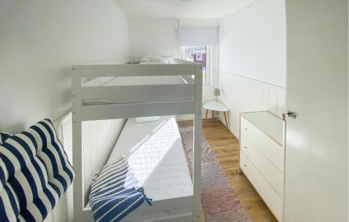 a bunk bed in a small room with a ladder at Nice Home In Tived With Lake View in Tived