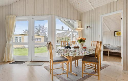 a dining room with a table and chairs at 2 Bedroom Lovely Home In Otterup in Otterup