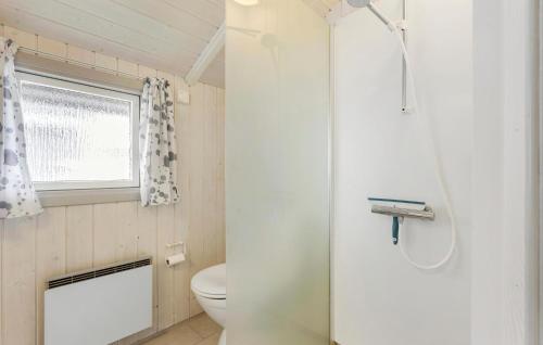 a small bathroom with a toilet and a window at 2 Bedroom Lovely Home In Otterup in Otterup