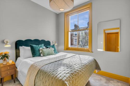 a bedroom with a large bed and a window at Hammersmith Residences by MySquare in London