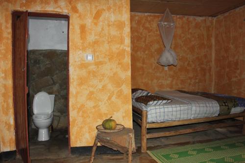 Ένα ή περισσότερα κρεβάτια σε δωμάτιο στο Red Rocks Rwanda - Campsite & Guesthouse