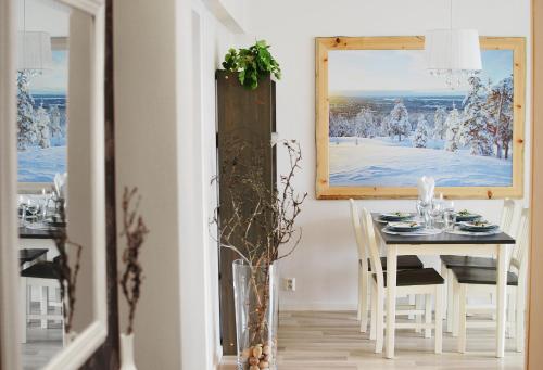 a dining room with a table and a window at Piriko City Centre Apartment in Rovaniemi