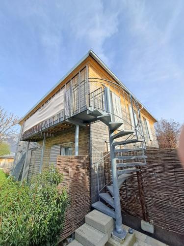 a house with a spiral staircase in front of it at Schöne Ferienwohnung in Feldkirch