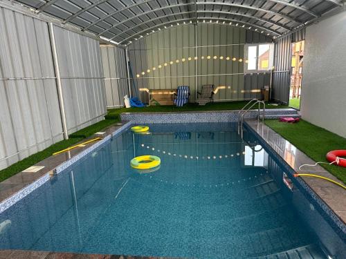 a swimming pool with two frisbees in it at Apartment with swimming pool in Wāsiţ