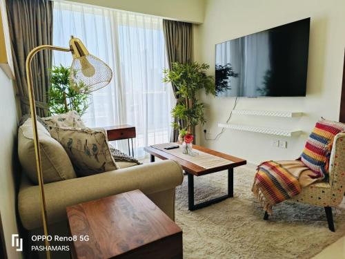 a living room with a couch and a table at Reva Residence Luxurious 2 BHK in Dubai