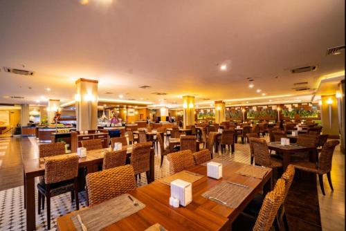 a restaurant with wooden tables and chairs at Ambassador Hotel & Spa- All Inclusive in Kemer