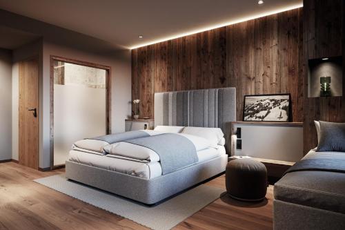 フィーバーブルンにあるADEA Lifestyle Suites Fieberbrunnのベッドルーム(ベッド1台、ソファ付)