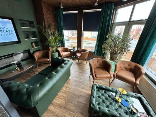 a living room with a couch and chairs at Hotel Neon in Blackpool