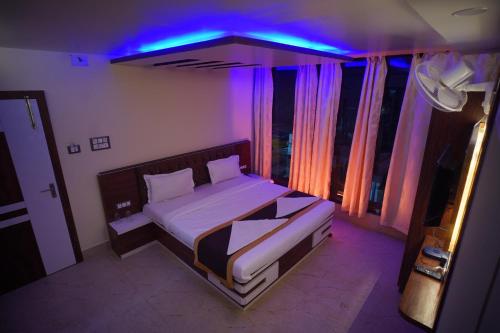 Hotel Asha Innにあるベッド