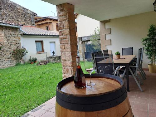 a bottle of wine sitting on top of a barrel at Casa Rural Torreblanca in Urroz