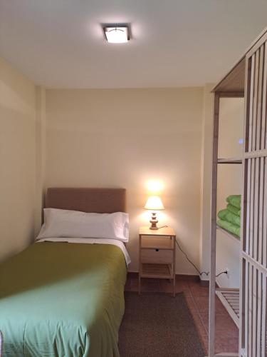 a bedroom with a bed and a lamp on a table at Casa Rural Torreblanca in Urroz