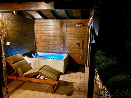 a bath tub with a chair and an american flag at B&B Desenzano Paradise in Desenzano del Garda