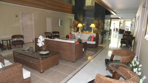 a living room with couches and tables and chairs at Ambassador Hotel & Spa- All Inclusive in Kemer