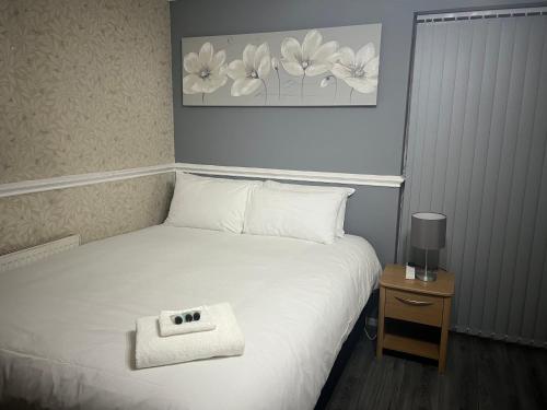 a bedroom with a bed with a white pillow on it at Becky's Lodge - Strictly Single Adult Room Stays - No Double Adult Stays Allowed in Solihull
