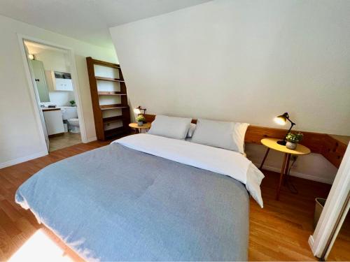 1 dormitorio con 1 cama grande y 1 mesa en Le Jackrabbit Orford Domaine Cheribourg en Orford