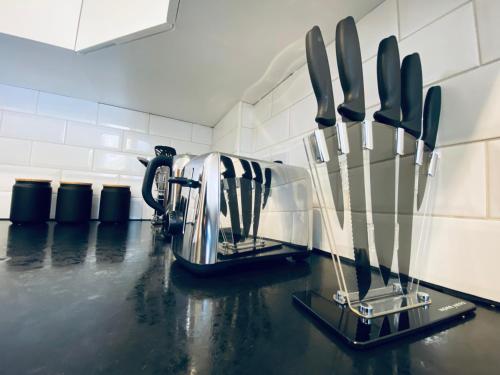 un comptoir de cuisine avec des couteaux sur un comptoir dans l'établissement Luxury 3 Bed Apt in Camden, à Londres