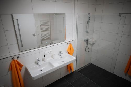 a white bathroom with a sink and a shower at Premium Apartments Monterra in Petschnitzen
