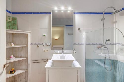 a white bathroom with a sink and a shower at Villa Christiane in Ses Salines