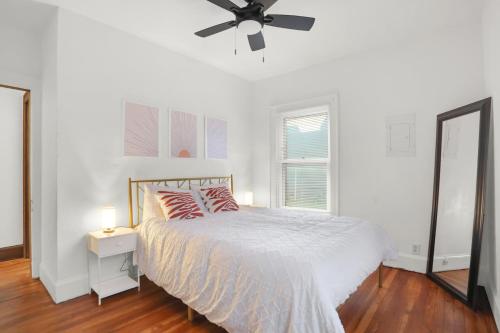 1 dormitorio blanco con 1 cama y ventilador de techo en Comfy Apartment in Indianapolis en Indianápolis