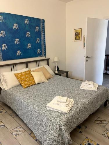 a bedroom with a bed with two towels on it at Villa Luisa B&B in Sperlonga