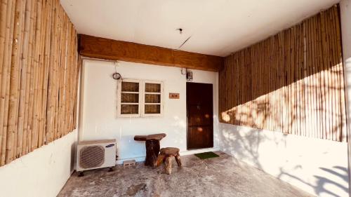 an empty room with a table and a window at Alissia House No 518 in Koh Tao
