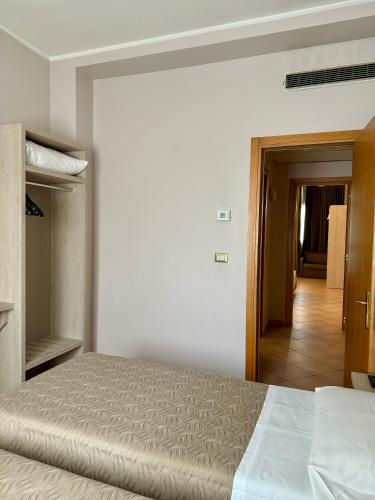 a bedroom with a bed and a door to a hallway at Hotel Miramonti in Turin