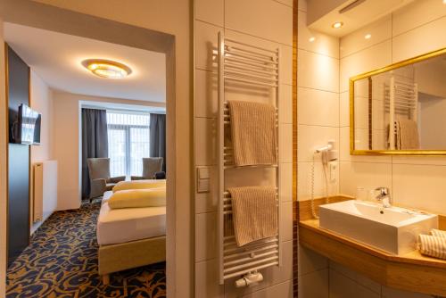 a hotel bathroom with a sink and a mirror at Hotel Wurzer in Tännesberg