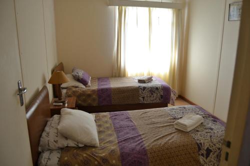 a hotel room with two beds and a window at Bets Guesthouse in Gariepdam