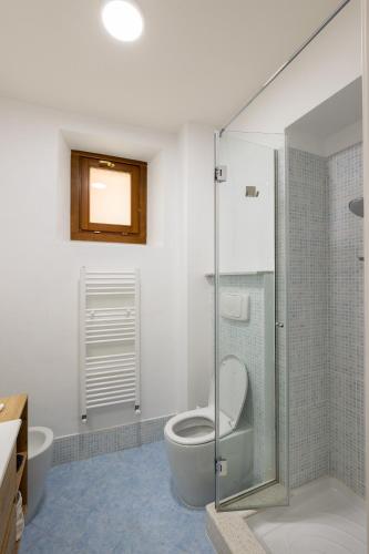 a bathroom with a toilet and a glass shower at [HEART OF TUSCANY] PINOCCHIO’S in Collodi
