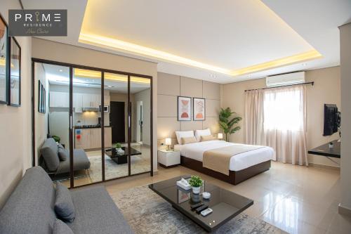 a bedroom with a bed and a living room at Prime Residence New Cairo in Cairo