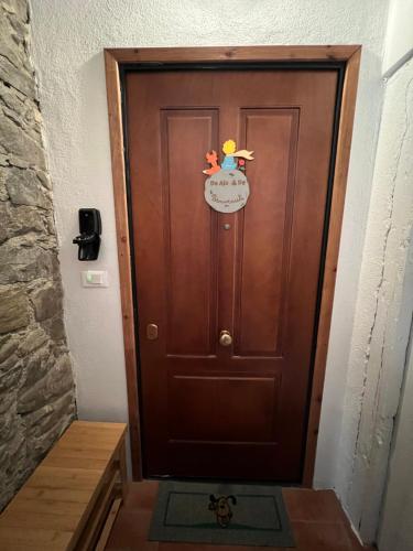 a wooden door with a hello kitty sticker on it at Da Ale e De in Isolabona