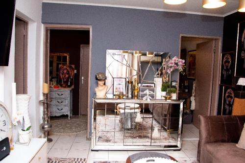Villa Raissa 2 في ليبرفيل: غرفة معيشة مع طاولة مع مرآة