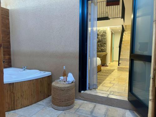 a bathroom with a bath tub and a sink at Adama Boutique Hotel in Mitzpe Ramon