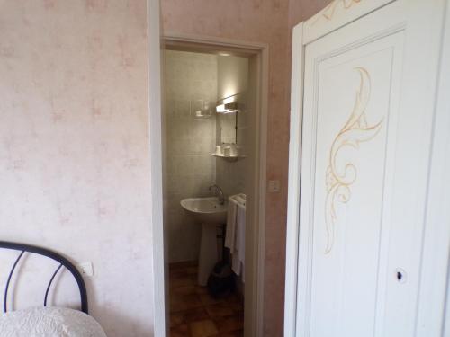 a small bathroom with a sink and a toilet at Le Relais de Boralde in Espalion