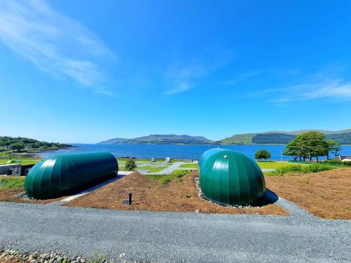 two green domes sitting on the side of a road at Port Nan Gael Pods in Pennyghael