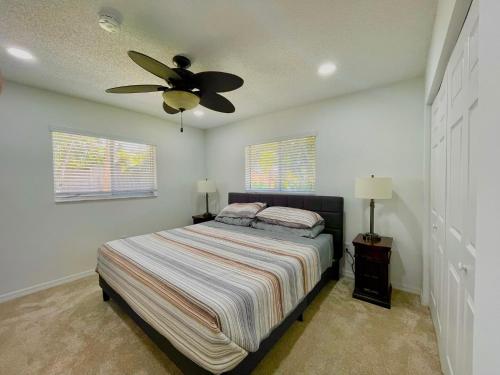 a bedroom with a bed and a ceiling fan at Fort Myers Beach Escape 3 Miles Away Sleep 7 in Fort Myers Beach