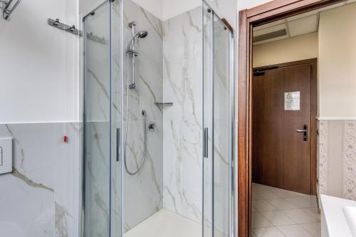 a bathroom with a shower and a glass door at Hotel Ottaviano Augusto in Rome