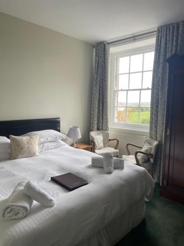 a hotel room with a bed with towels on it at Trevanger Farm Bed and Breakfast in Wadebridge