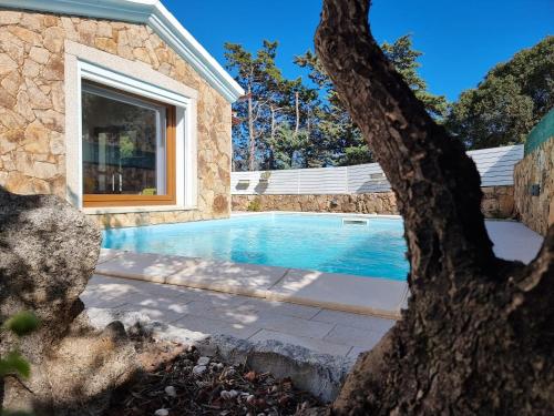 a swimming pool in the backyard of a house at Res S'Abbaida C1 con Piscina Privata in Tanaunella